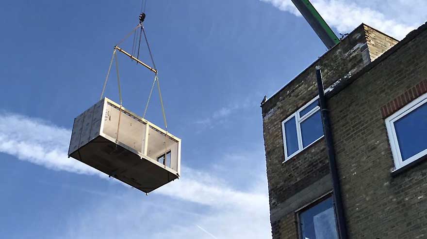 Image of modular loft extension being craned into position on a residential property