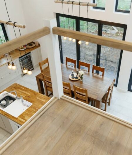 Featured image of barn conversion interior looking down from the mezzanine across an open plan kitchen diner.