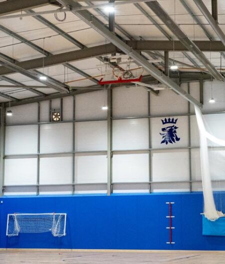 Featured interior image for Queen Elizabeth's Grammar School Sports Hall. Modern steel frame building fitted out with sports equipment.