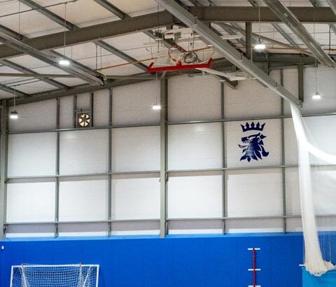 Featured interior image for Queen Elizabeth's Grammar School Sports Hall. Modern steel frame building fitted out with sports equipment.