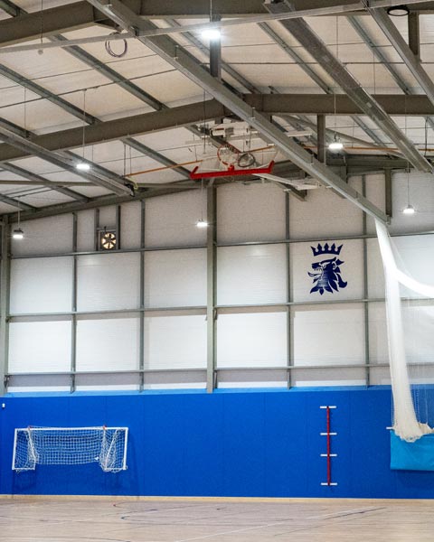 Featured interior image for Queen Elizabeth's Grammar School Sports Hall. Modern steel frame building fitted out with sports equipment.