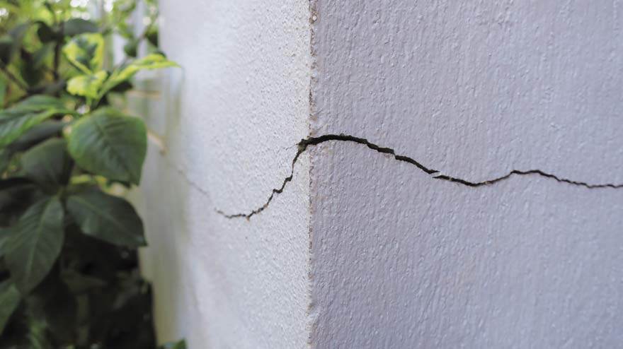 Close up of building walls with horizontal structural crack requiring structural report