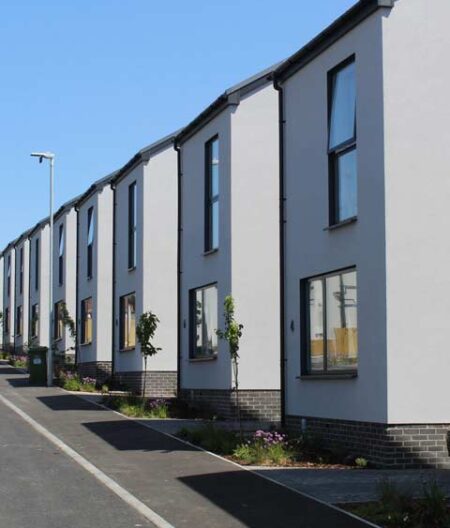 Featured image of a row of modern detached houses built using off-site modular construction.