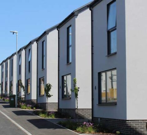 Featured image of a row of modern detached houses built using off-site modular construction.