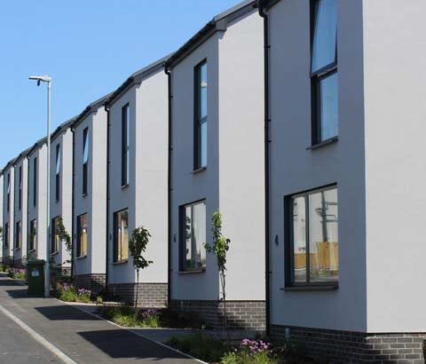 Featured image of a row of modern detached houses built using off-site modular construction.